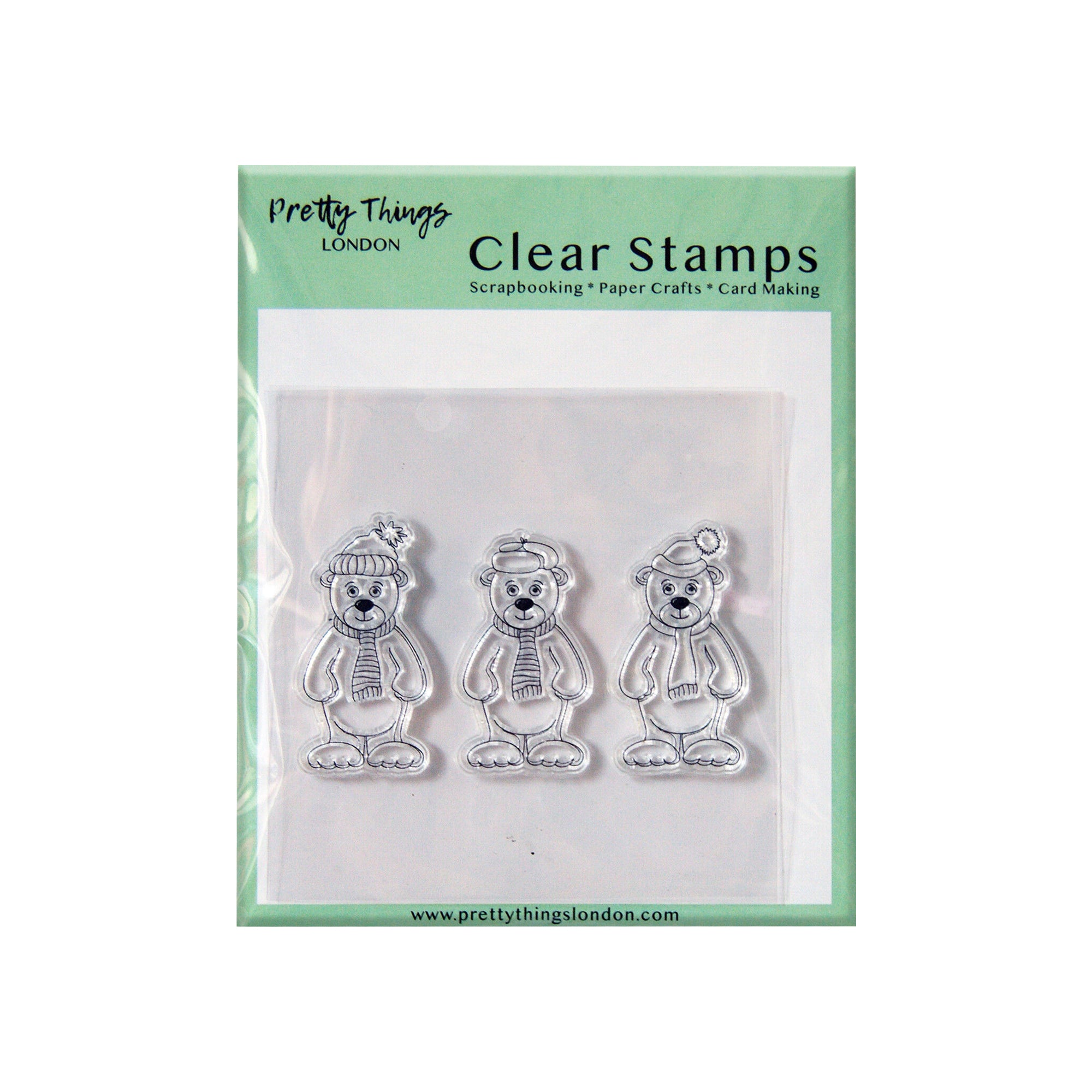 A set of three clear stamps featuring winter bears, each wearing a scarf and a different winter hat. The packaging reads 'Pretty Things London - Clear Stamps' for scrapbooking, paper crafts, and card making.